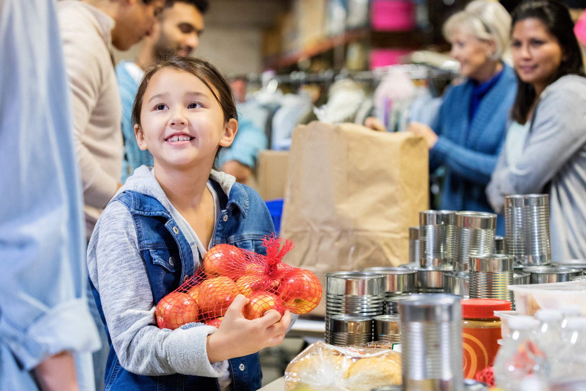 smiling little girl donates apples to food bank smiling little girl donates apples to food bank