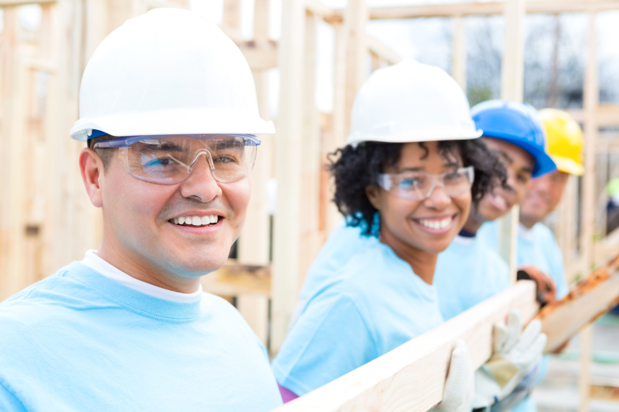 diverse team of volunteers build home for charity diverse team of volunteers build home for charity