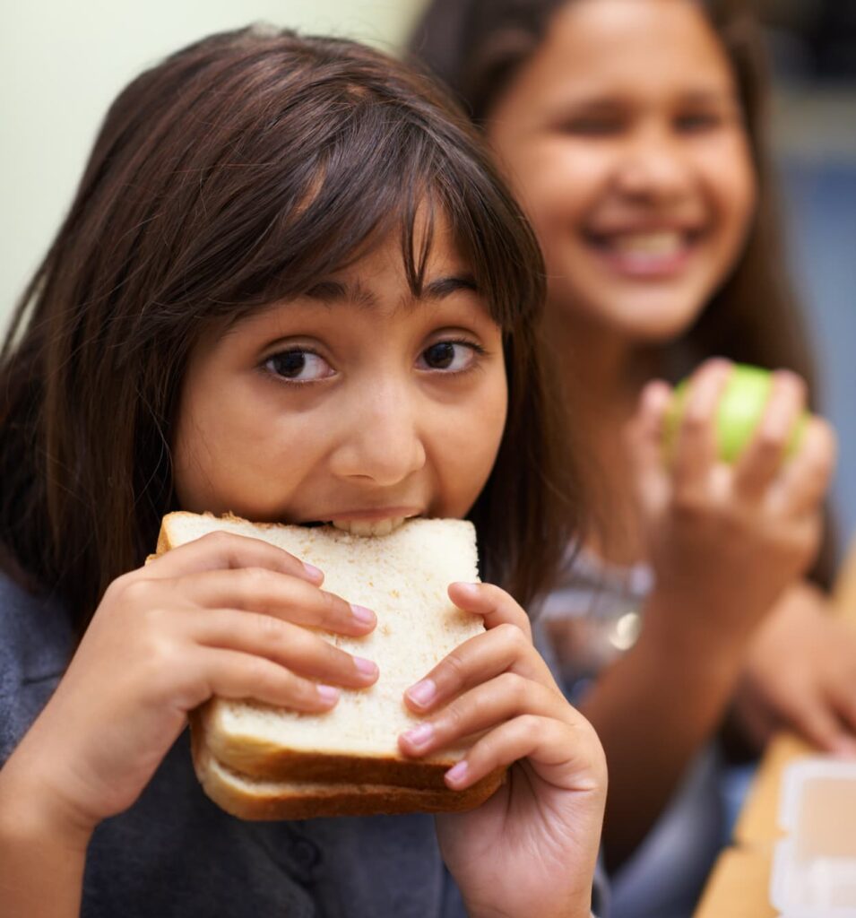 hungry young girl student eating sandwich